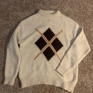 Knitted wool sweater with a graphic on the front.